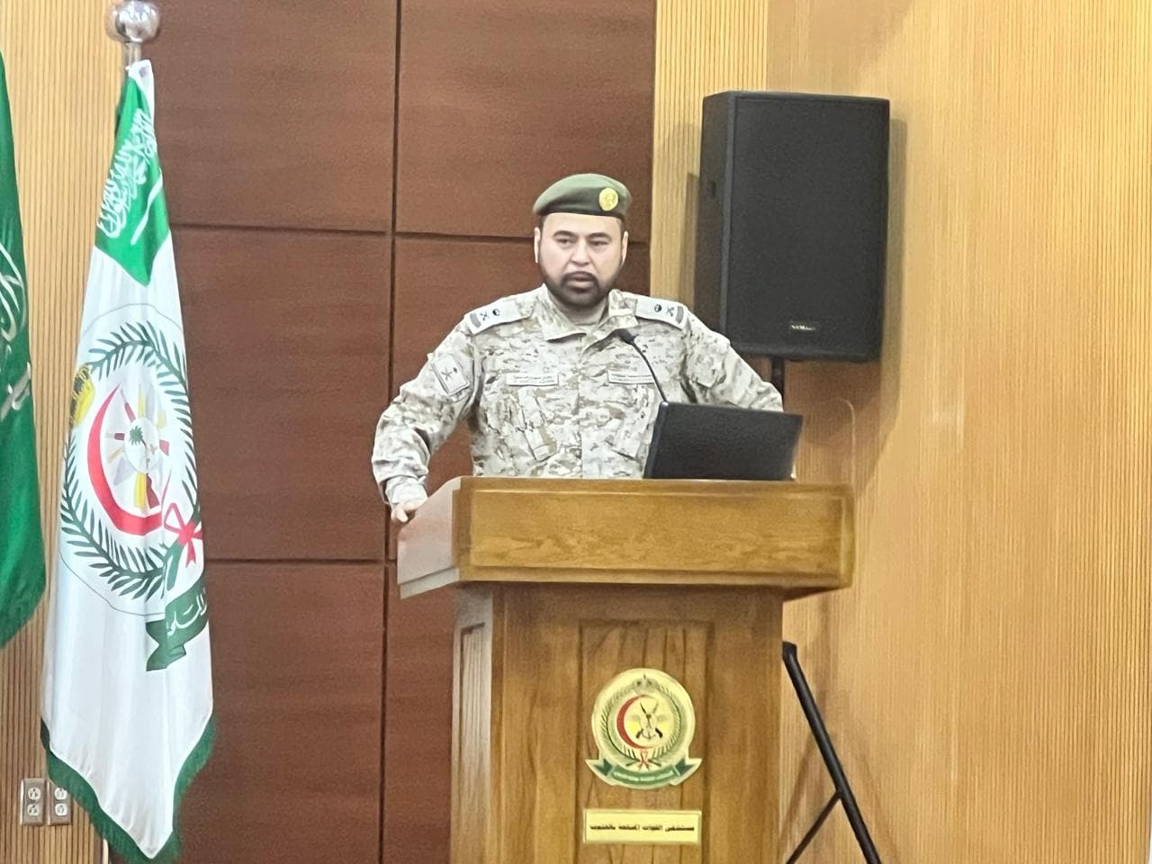 Major General Doctor Yasser Mandourah delivering speech at podium